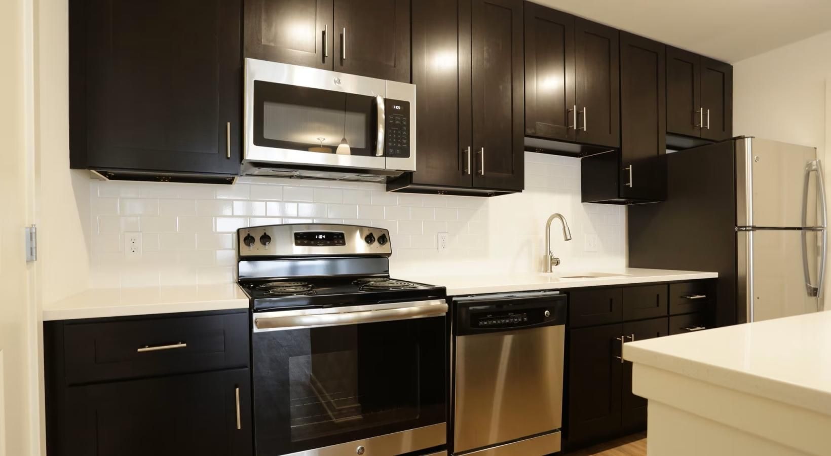 a kitchen with black cabinets