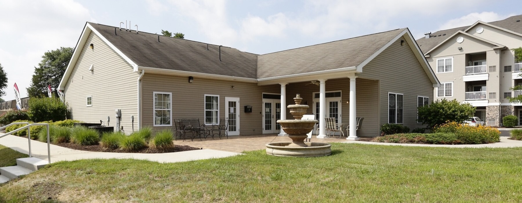 a building with a fountain in the front yard